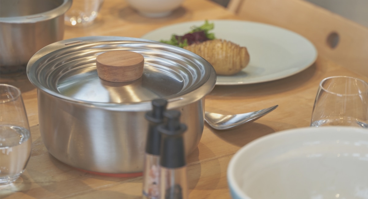 テーブルに置かれた鍋と食器の写真